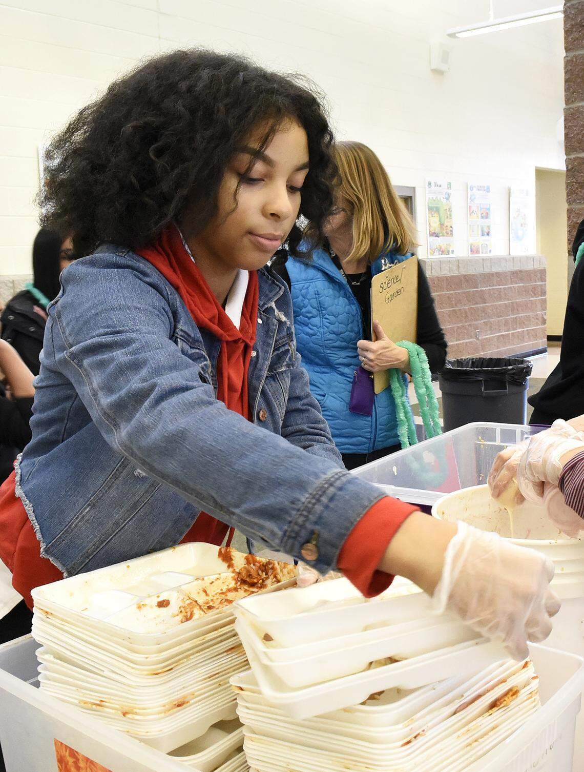 Destiny Davis, 14, stacks polystyrene trays during a food waste audit at Whitewater Middle School.