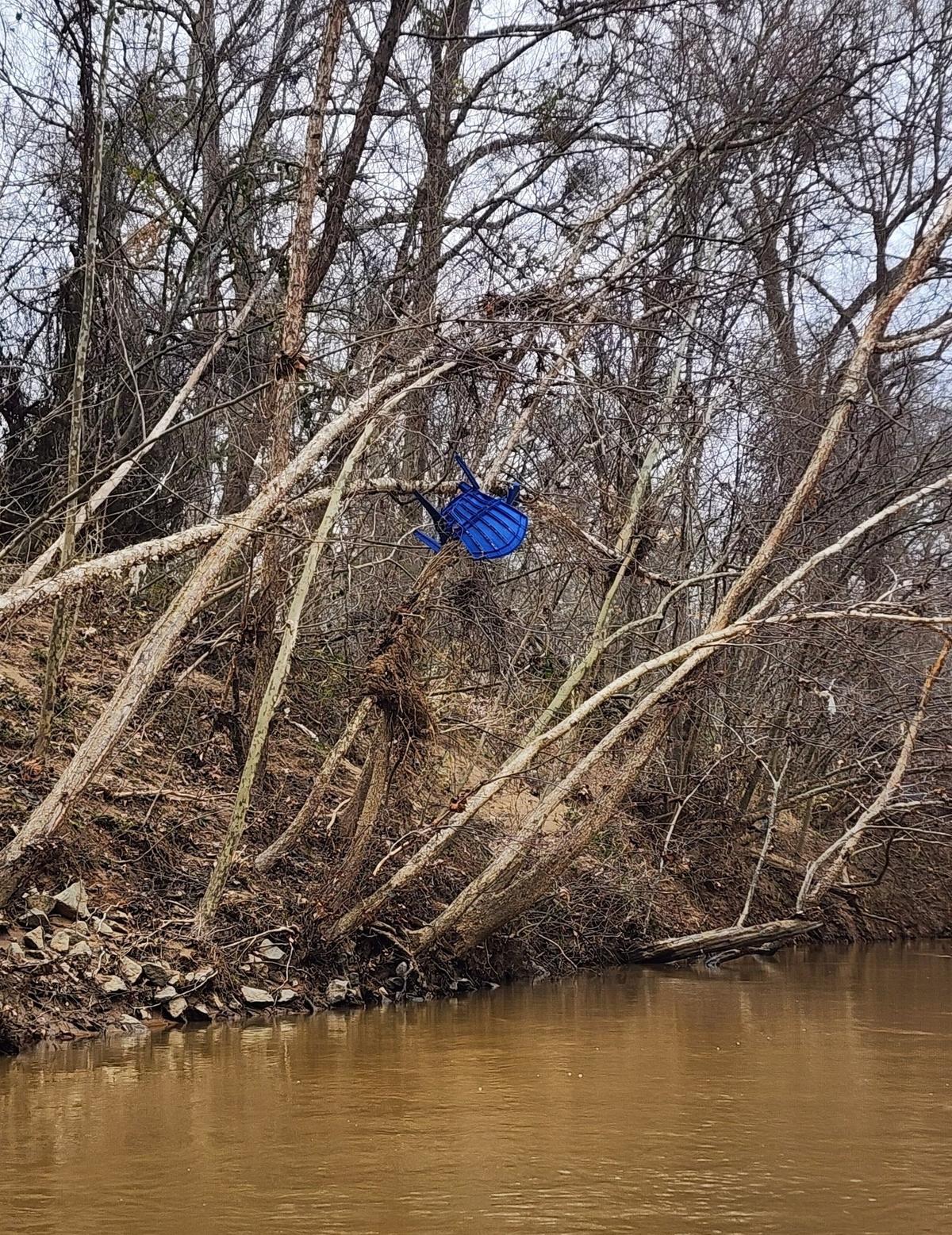 A chair, high above Dutchman’s Creek, remains stuck in a tree some six months after Helene’s floodwaters left it there.