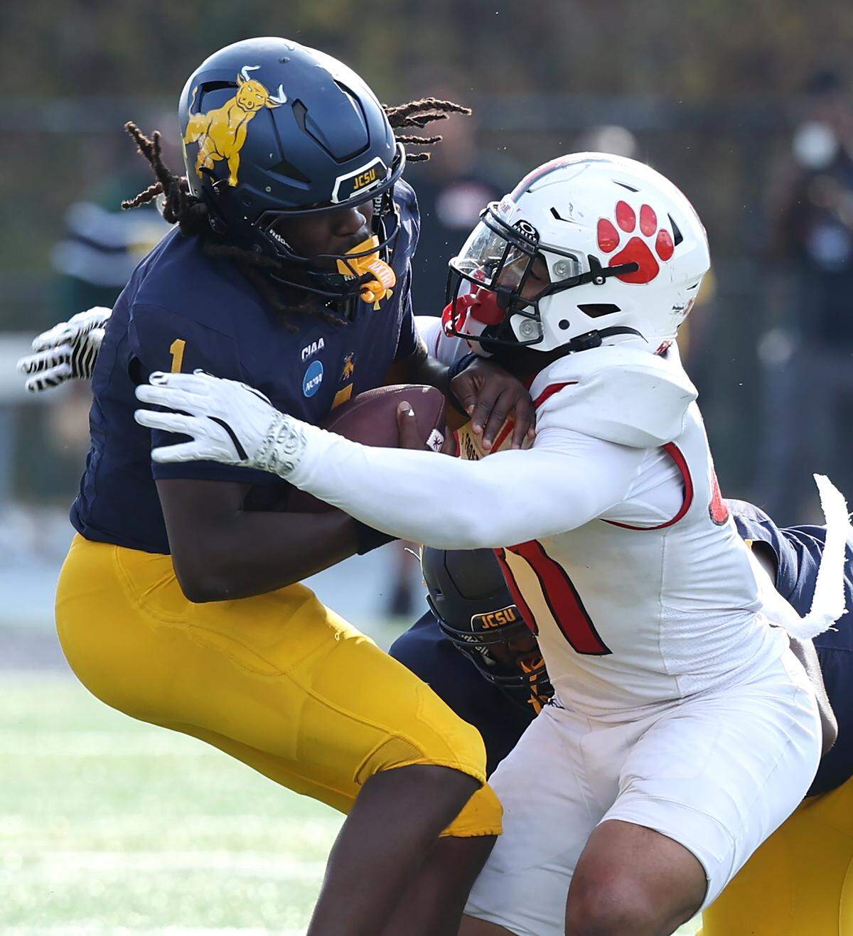 Johnson C. Smith University Golden Bulls quarterback Kelvin Durham, left, is sacked by Frostburg State defensive lineman Christian Taylor, right, during action at the Irwin Belk Complex in Charlotte, NC on Saturday, November 22, 2025.