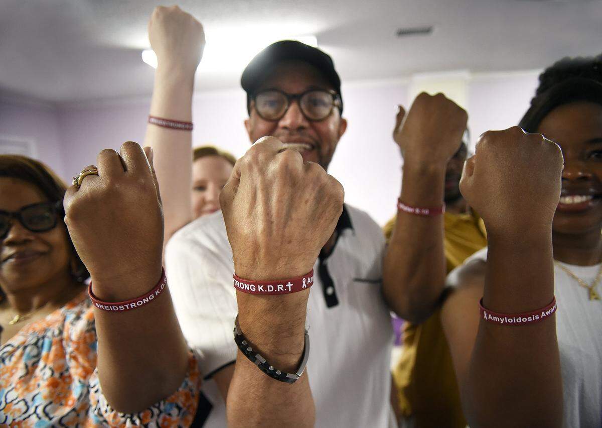 In support of Pastor Kelvis Reid, 65, from Gastonia, his family had bracelets made. Reid (center) collapsed on Christmas Eve after suffering multiple cardiac arrests. Diagnosed with AL amyloidosis - a rare and often fatal disease that mimics blood cancer and attacked both his heart and kidneys - he was placed on life support at Atrium Health Carolinas Medical Center. His survival was unlikely. But thanks to a coordinated effort between Atrium Health Sanger Heart & Vascular Institute and Atrium Health Levine Cancer, through their specialized cardio-oncology program, and continual support from his family, Pastor Reid became one of the few patients in the region to receive a dual heart and kidney transplant. Today, he's not only alive - he's back in the pulpit and recently completed a 5K. We met with Reid on Saturday, August 16, 2025.