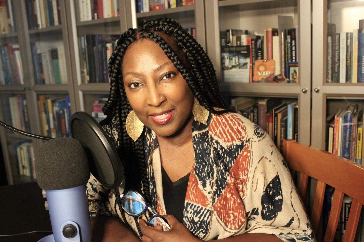 Dawn Anthony, in her home library, also has a podcast. She spent much of the last 18 months as a caretaker for ill family members.