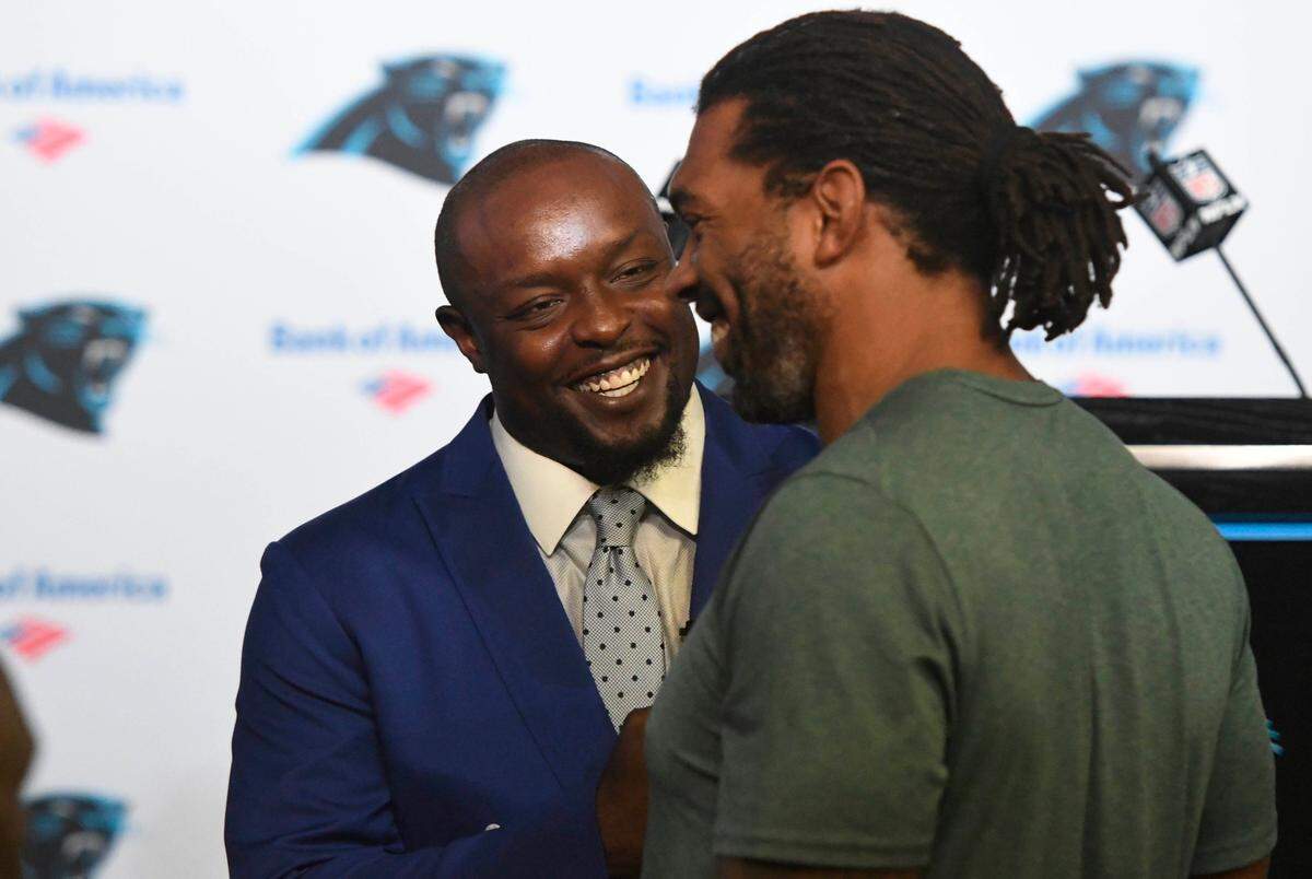 Former Carolina Panthers defensive end Charles Johnson, who is second all-time in sacks in the the franchise’s history, talks with Julius Peppers, after a retirement press conference for Johnson at Bank of America Stadium on Thursday, August 23, 2018.