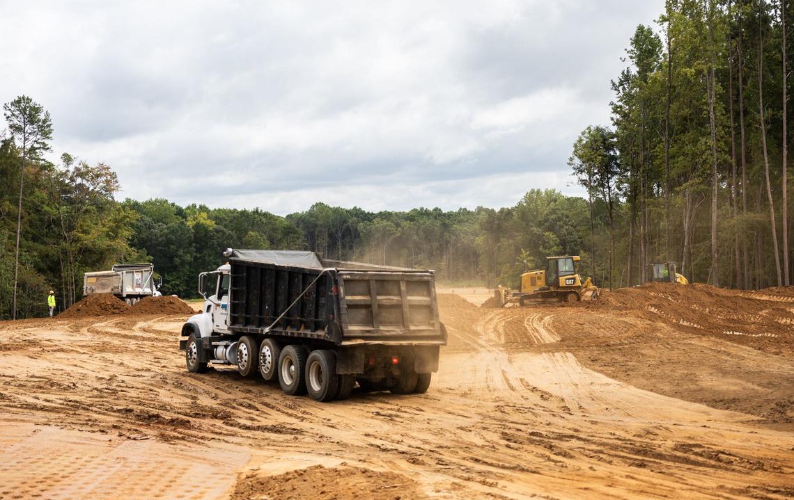 A construction crew builds the East-West Connector in Mooresville, N.C., on Friday, September 13, 2024. Two years from completion, the connector has already attracted major housing subdivisions and a planned mega mixed-used community.