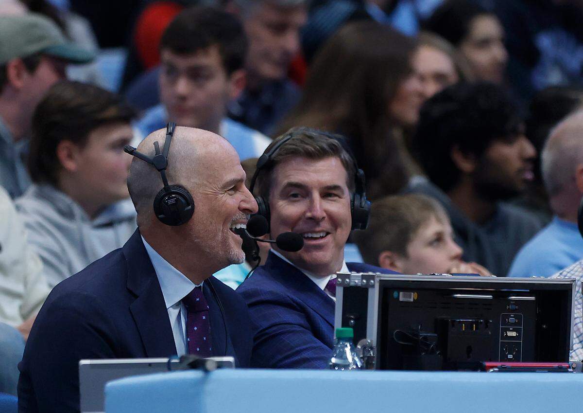 ESPN college basketball analyst Jay Bilas, left, smiles during the first half of North Carolina’s 97-73 win over N.C. State on Wednesday, Feb. 19, 2025, at the Smith Center in Chapel Hill, N.C.