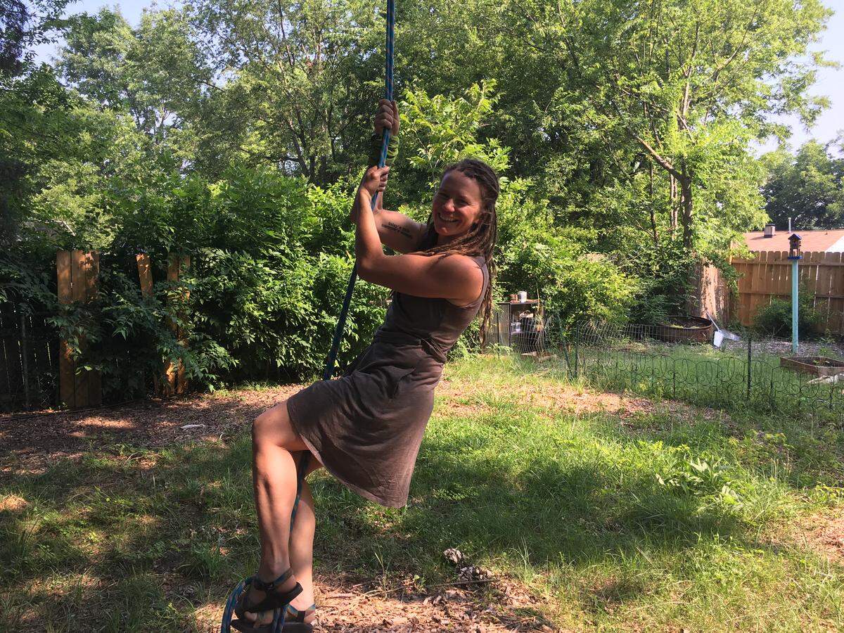 In order to prepare for competitions, Nicole Benjamin climbs trees in the backyard at her home in Pineville, North Carolina.
