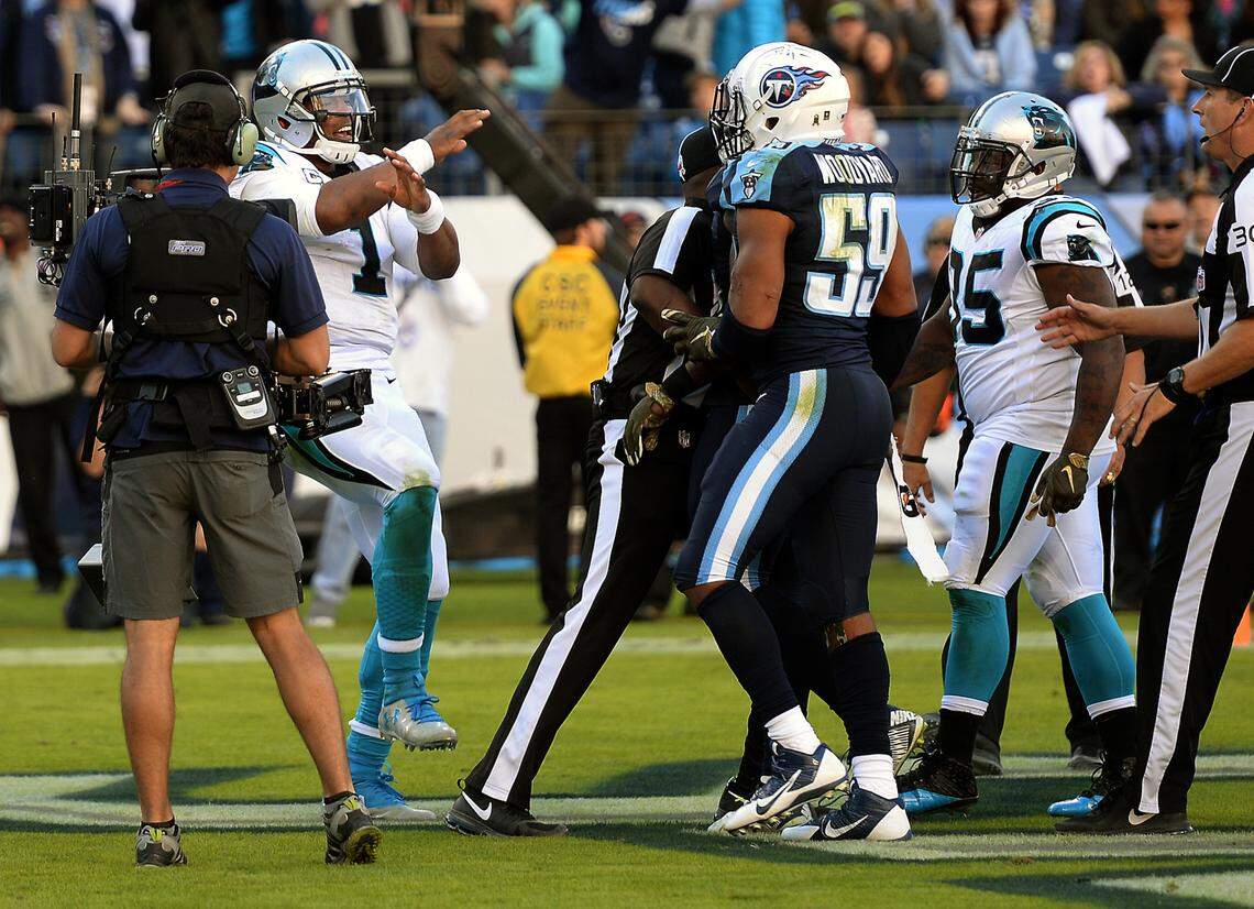 Cam Newton, left, taunts Tennessee Titans linebacker Wesley Woodyard during the Panthers win in November 2015.