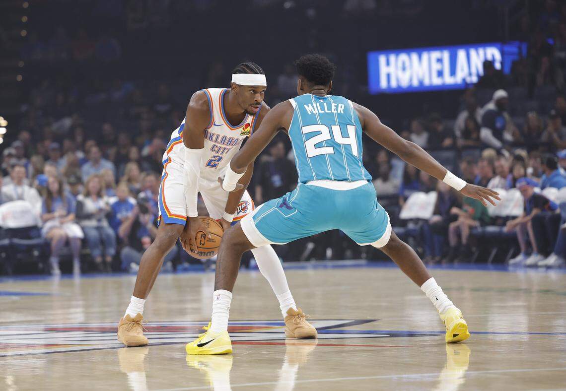 Oklahoma City Thunder guard Shai Gilgeous-Alexander is defended by Charlotte Hornets forward Brandon Miller  during the first quarter of a game between the Charlotte Hornets and the Oklahoma City Thunder at Paycom Center. 