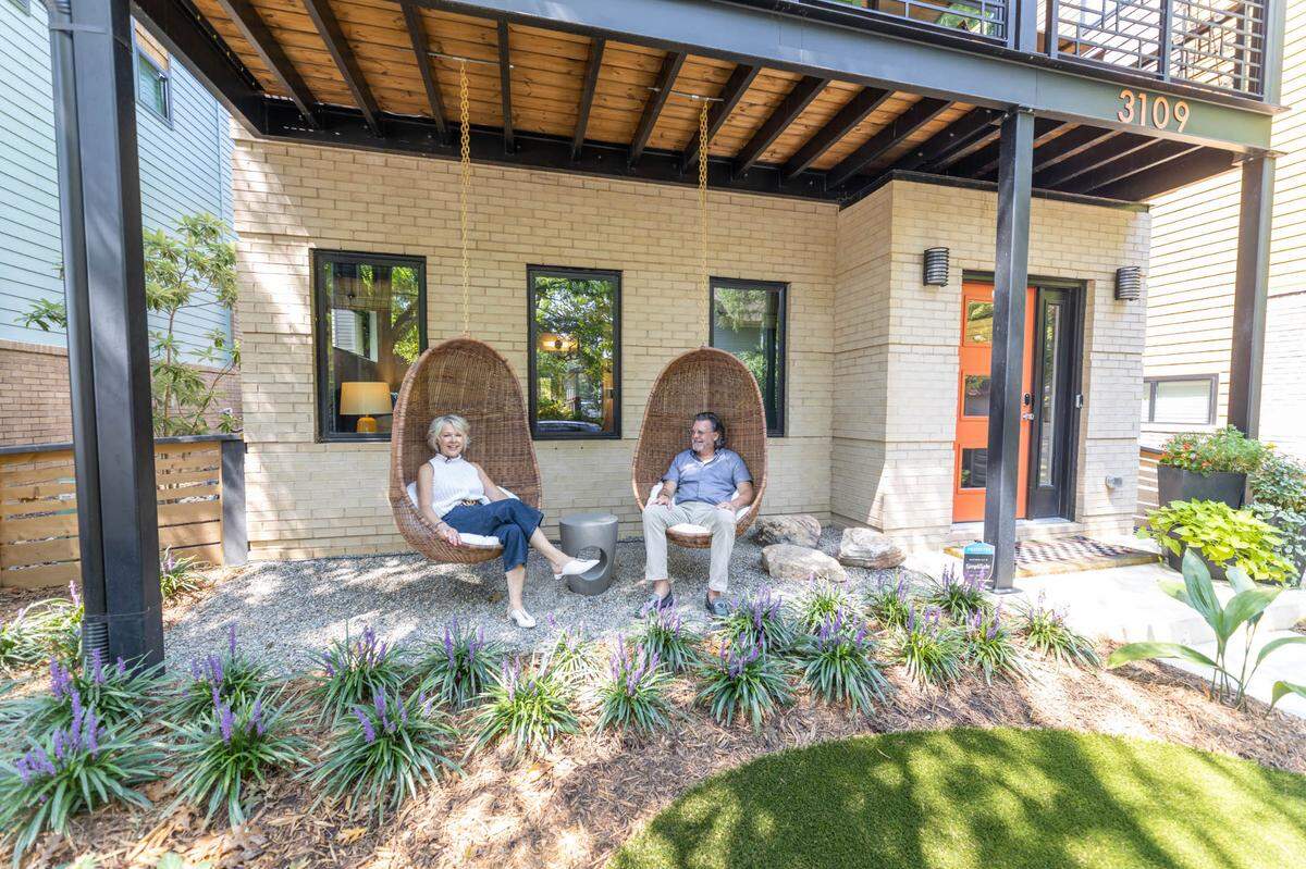 Rachel and Craig Richards often enjoy morning coffee in their egg chairs outside of their modern NoDa home.