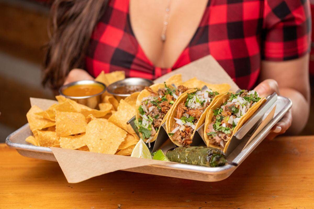 Crispy tacos from Twin Peaks made with spicy ground beef, pepper jack cheese, pico de gallo, sour cream and cilantro.