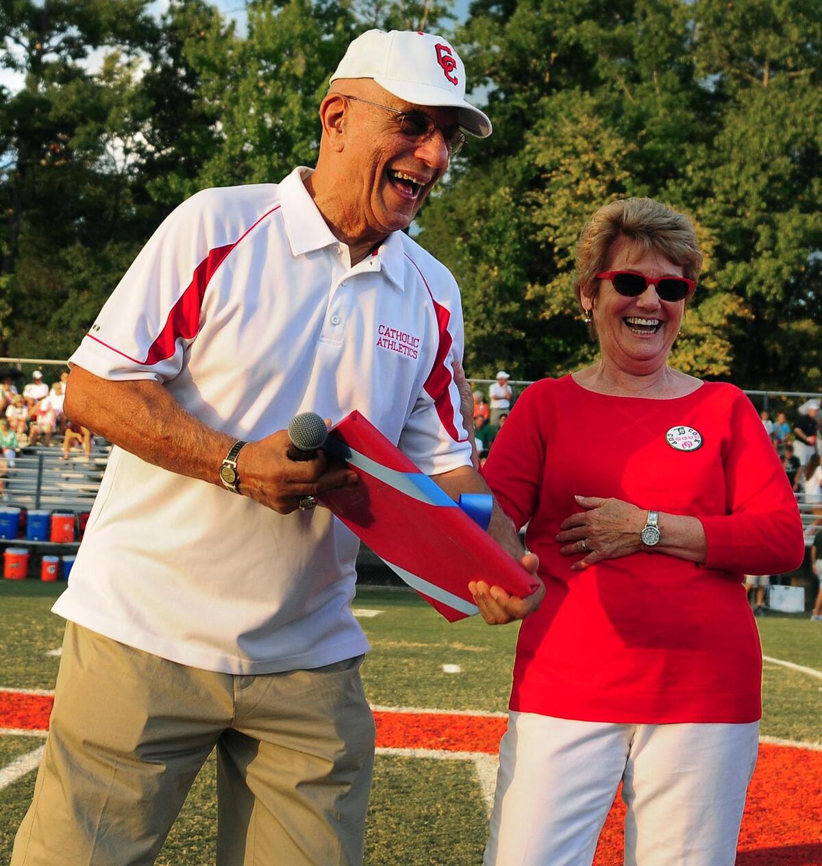 Former Charlotte Catholic head coach Jim Oddo shares a laugh with his wife, Lorraine Oddo prior to the team’s game vs Charlotte Country Day in the Cook Cup at Charlotte Catholic on Friday, September 5, 2014.