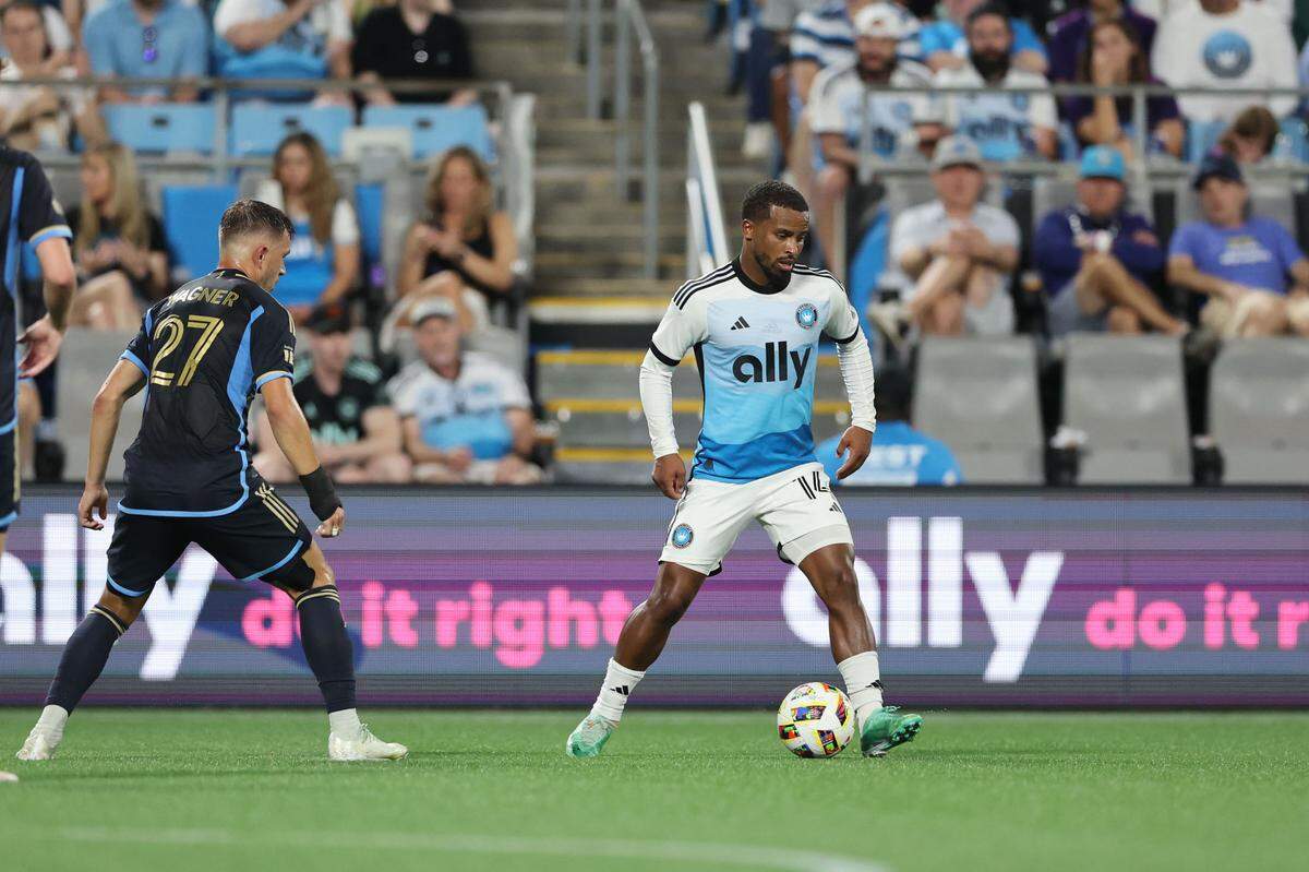 Charlotte FC defender Nathan Byrne (14) controls the ball against Philadelphia Union defender Kai Wagner (27) in the second half at Bank of America Stadium.