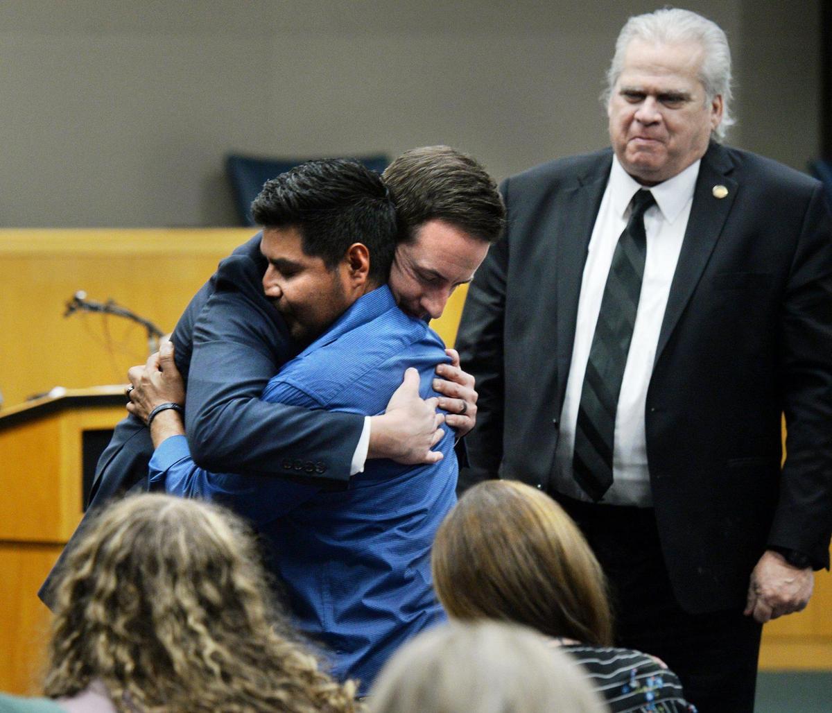Travis Page, the Gaston County district attorney, shared a hug with Santiago Lagunas, Liam Lagunas’ father, after Page and Rep. John Torbett (R-Gaston, on right) discussed House Bill 246, which cracks down on street racing. 