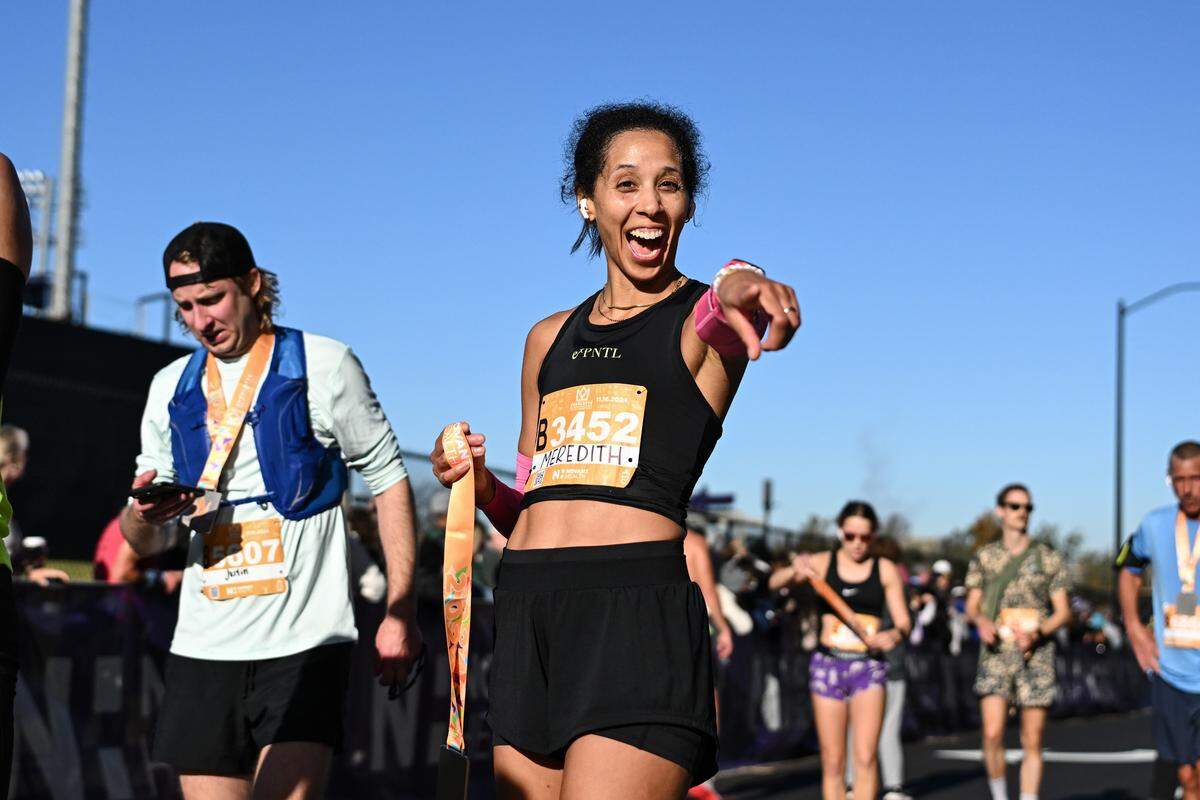 A participant smiles after taking part in the 20th annual Novant Health Charlotte Marathon on Saturday, Nov. 16, 2024, in Charlotte.