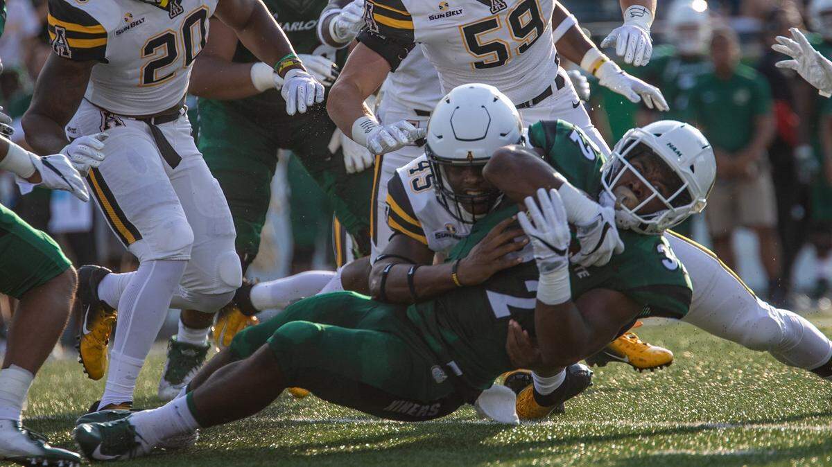 Charlotte’s Benny LeMay (32) is brought down by Appalachian State’’s Trey Cobb (45) in their game last season.