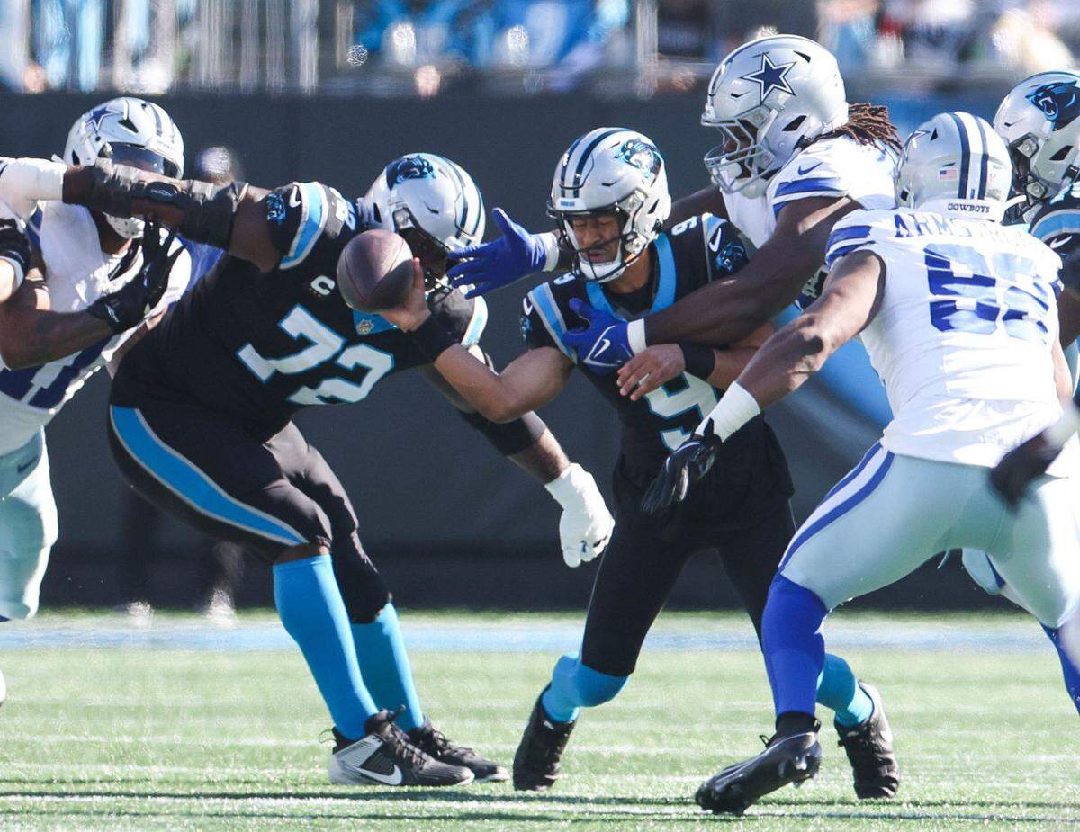 Panthers quarterback Bryce Young (9) is tackled during a pass by Cowboys defensive tackle Mazi Smith (58) during the game at Bank of America Stadium on Sunday, November 19, 2023 in Charlote, NC.