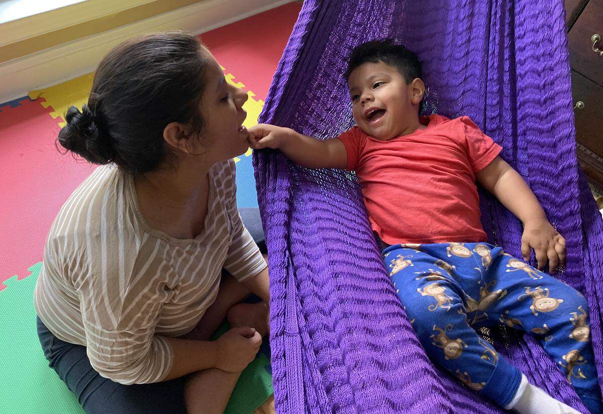 Yobania Nieto asks her 2-year-old son Jesseht to point to her mouth during playtime. Jesseht suffers from hypotonia, a muscle condition, and other medical ailments. The family moved from Nicaragua with the hopes of getting him medical help.