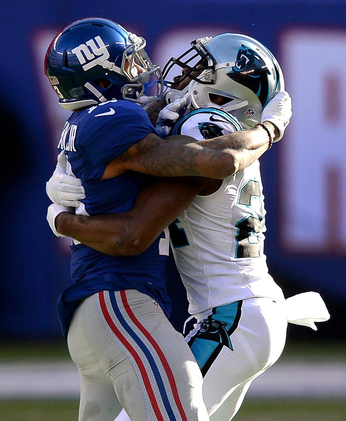 New York Giants wide receiver Odell Beckham Jr., left, and Carolina Panthers cornerback Josh Norman, right, wrap one another up during first-quarter action at MetLife Stadium in East Rutherford, NJ on Sunday, December 20, 2015. The Panthers defeated the Giants 38-35, while Beckham and Norman waged their own private war throughout the game.