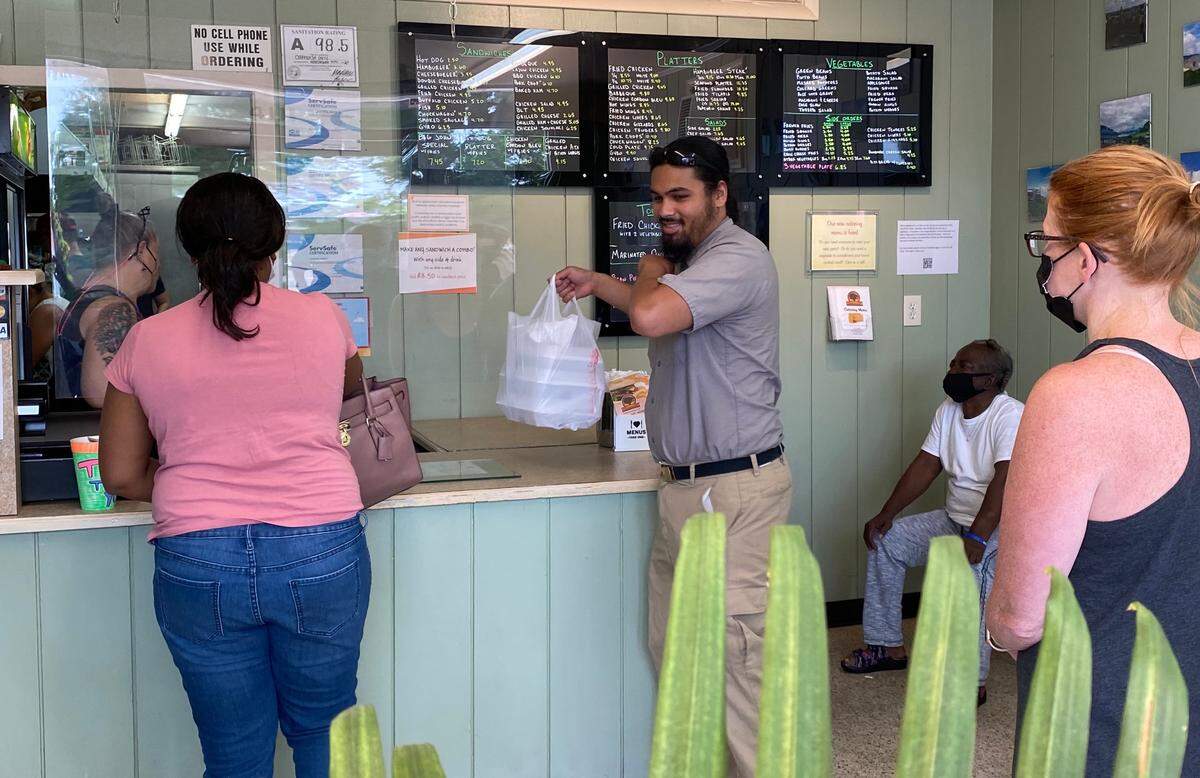Lunch customers line up Tuesday inside Oakhurst Grill.