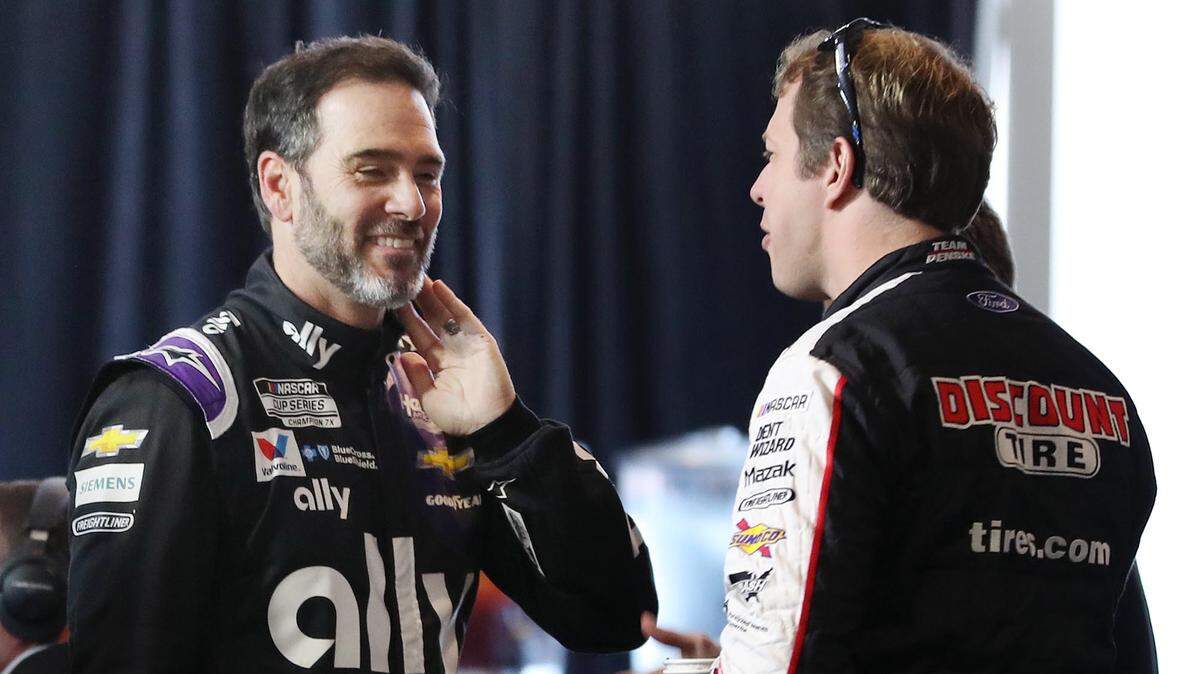 Former NASCAR driver Jimmie Johnson, left, pictured here with Brad Keselowski at Daytona 500 Media Day in 2020, will race a full IndyCar schedule in 2022.
