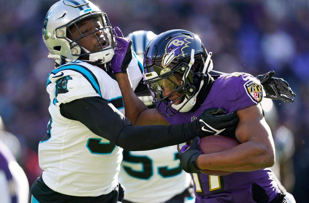 Carolina Panthers defensive end Brian Burns (left) makes the stop of Baltimore Ravens running back Kenyan Drake, right, in the first half of an NFL football game Sunday, Nov. 20, 2022, in Baltimore. (AP Photo/Patrick Semansky)