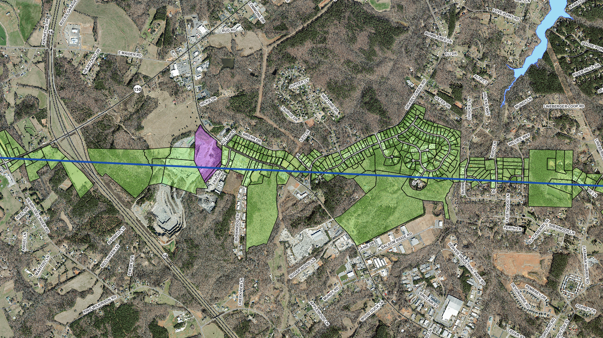This map shows a number of land parcels that will partially or entirely change counties starting on Feb. 2. The blue line reflects the new county line. Green-colored parcels were originally in Lincoln County. The single purple parcel originally was in Catawba County.