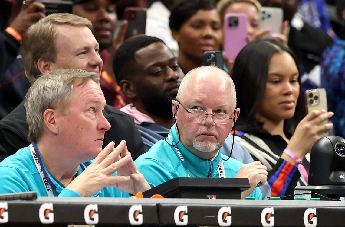 Charlotte Hornets longtime official scorer Michael Harwood, right, looks toward the team’s bench during a break in the action against the Golden State Warriors on Monday, March 3, 2025 at Spectrum Center in Charlotte, NC.