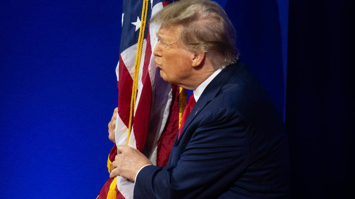 Former President Donald Trump kisses the flag as he arrives to make remarks at the 2024 Conservative Political Action Conference (CPAC) in National Harbor, Maryland on February 24, 2024.