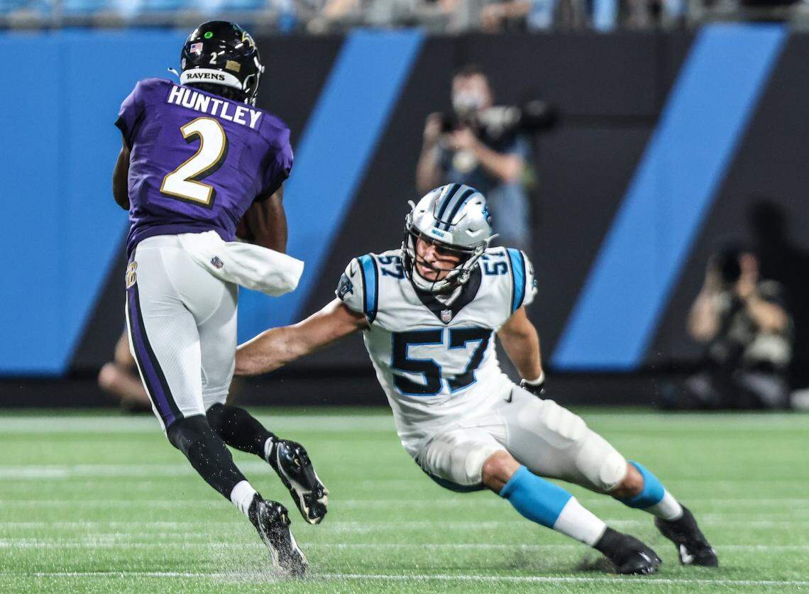 Baltimore Ravens Tyler Huntley, left, is tackled by Carolina Panthers Clay Johnston at the Bank of America Stadium in Charlotte, N.C., on Saturday, August 21, 2021.