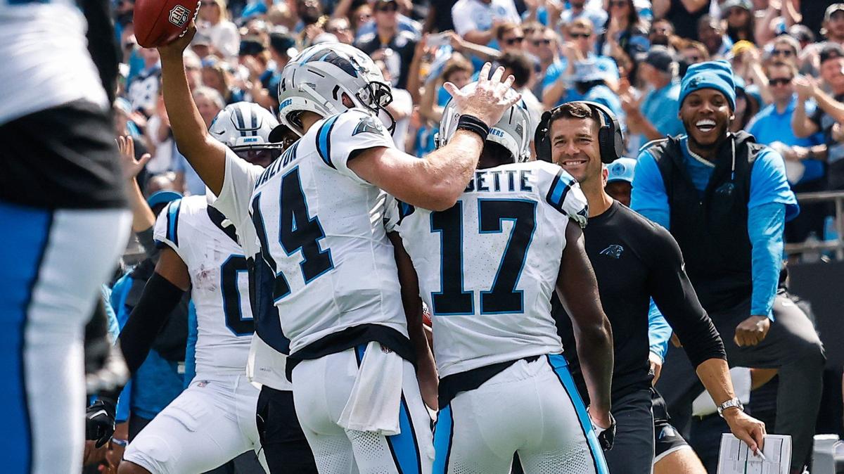 Panthers head coach Dave Canales, second from right, smiles as wide receiver Xavier Legette (17) approaches the sideline after scoring a touchdown during the game against the Bengals at Bank of America stadium in Charlotte, NC on Sunday, September 29, 2024.