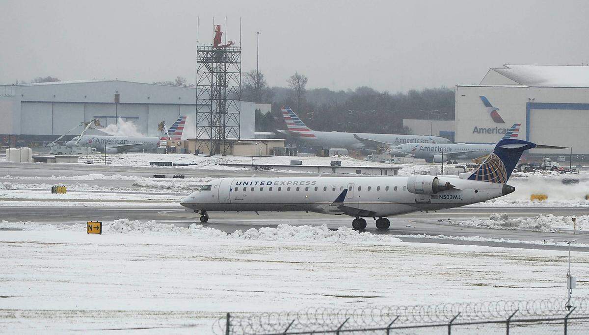 Airplanes taxi on the runway at Charlotte Douglas International Airport despite snowy conditional on Monday in December 2018.