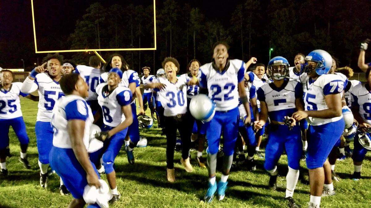 Garinger High’s players celebrate a win Friday over Harding High, the reigning N.C. 4A state champions