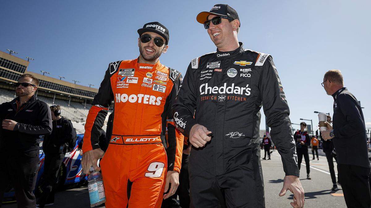 HAMPTON, GEORGIA - FEBRUARY 24: Chase Elliott, driver of the #9 Hooters Chevrolet, (L) and Kyle Busch, driver of the #8 Cheddar's Scratch Kitchen Chevrolet, talk on the grid during qualifying for the NASCAR Cup Series Ambetter Health 400 at Atlanta Motor Speedway on February 24, 2024 in Hampton, Georgia. (Photo by Alex Slitz/Getty Images)