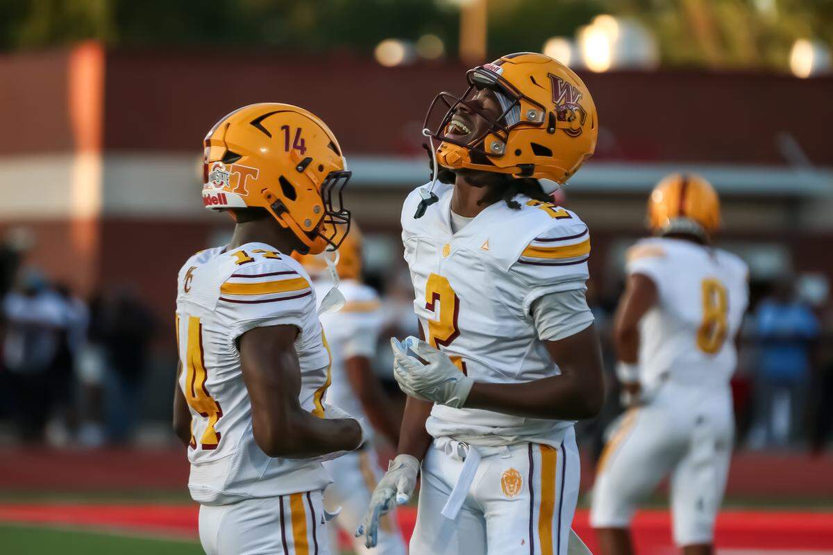 West Charlotte Donte Nicholson leaps in the air as teammates rush to celebrate his score at Monroe high school on Friday in Monroe.
