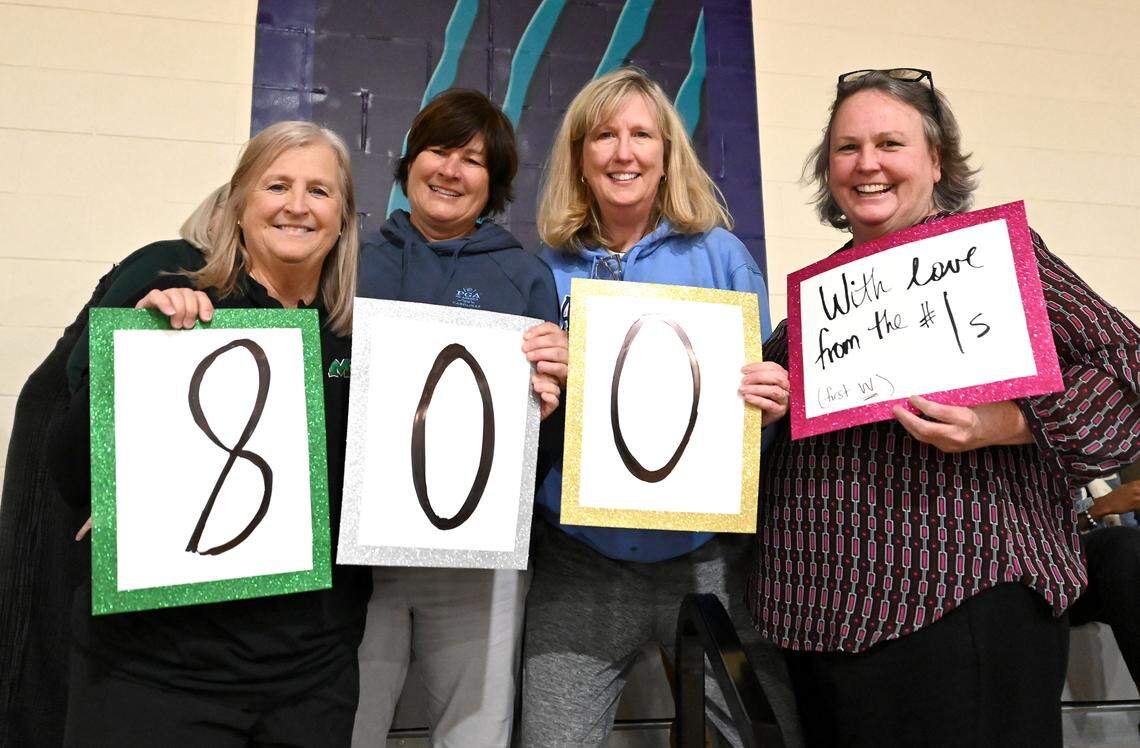 Myers Park head coach Barbara Nelson, left, stands with members of her first team following her winning her 800th career game on Tuesday, January 28, 2025 at Palisades High School. Nelson’s current Mustang team beat the Palisades Pumas 58-44.