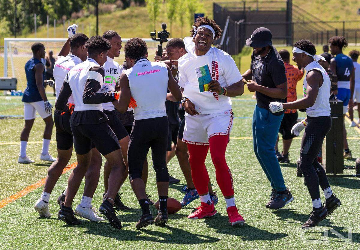Carolina Panthers quarterback Cam Newton breaks a huddle with one of his 7-on-7 All-Star teams. Newton said he believes he makes his “biggest impact” working with and mentoring the high school players on his all-star teams, which helps them reach the collegiate level both on and off the field.