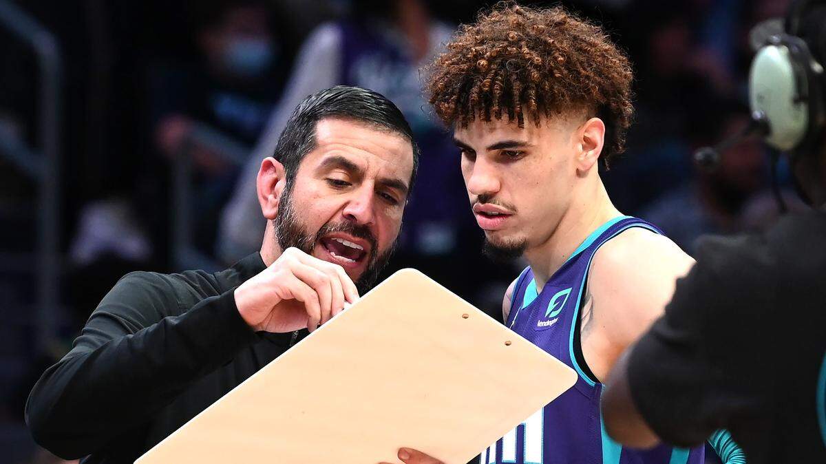 Charlotte Hornets head coach James Borrego, left, speaks with guard LaMelo Ball, right, during the Hornets’ 140-129 overtime loss to Boston Monday night.
