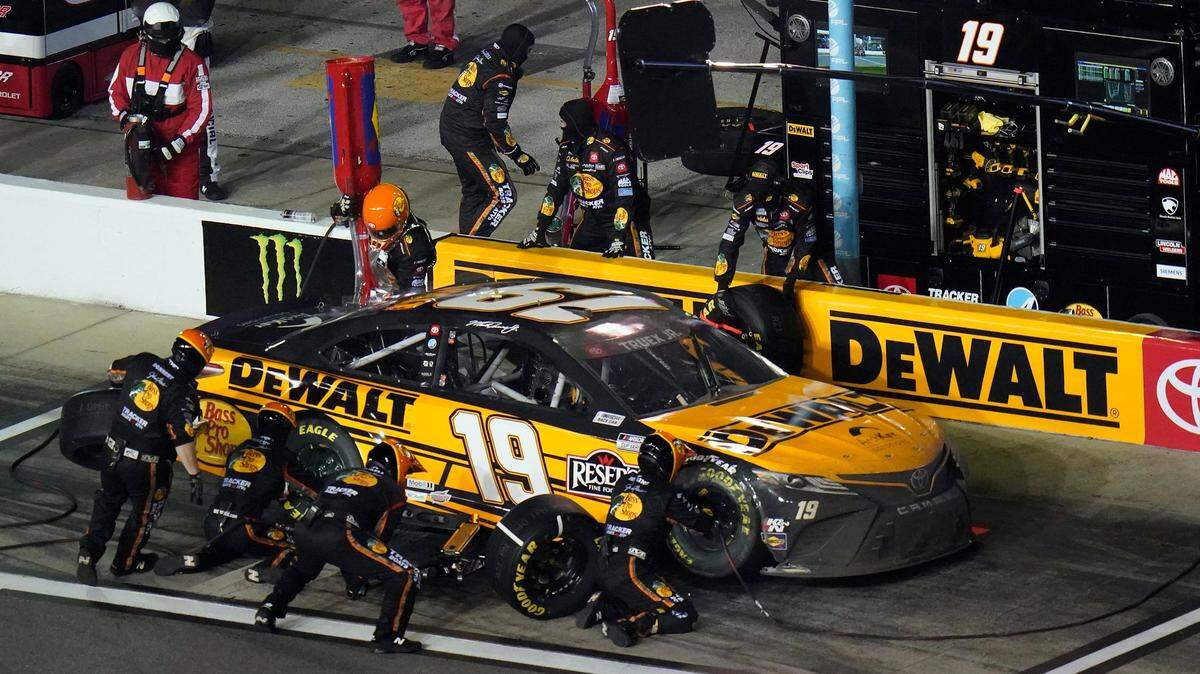 Martin Truex Jr.’s crew changes tires during a pit stop on the car during the NASCAR Daytona Clash auto race Tuesday, Feb. 9, 2021, at Daytona International Speedway in Daytona Beach, Fla. (AP Photo/Chris O’Meara)
