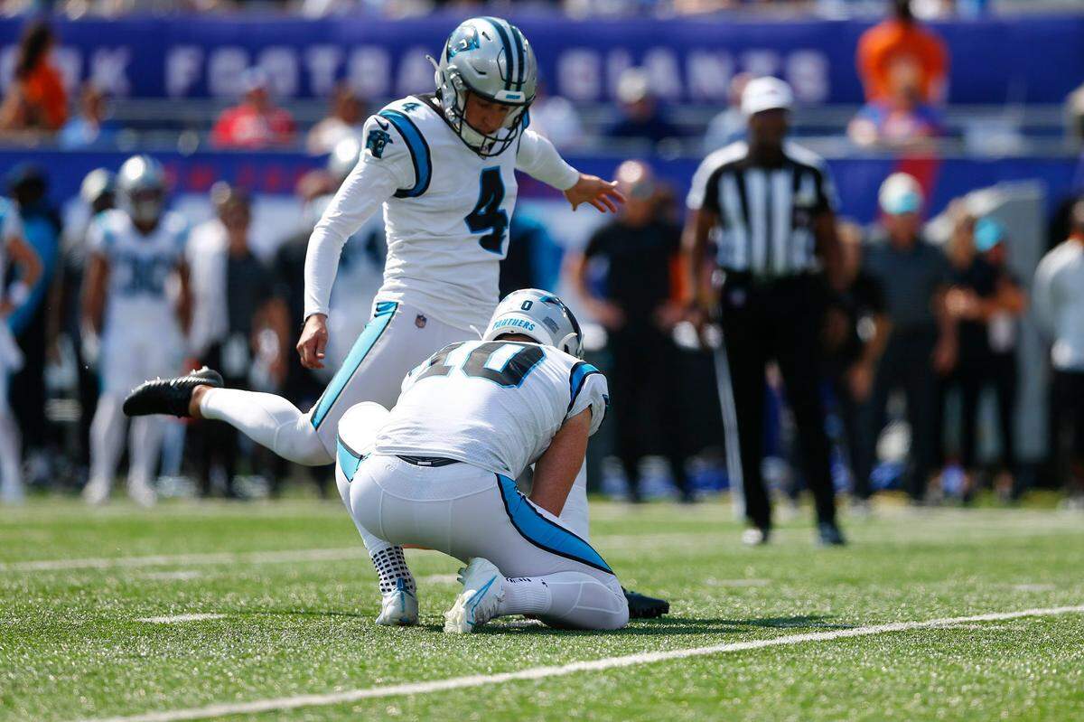 Carolina Panthers kicker Eddy Pineiro, left, kicks a field goal during the first half an NFL football game against the New York Giants, Sunday, Sept. 18, 2022, in East Rutherford, N.J. (AP Photo/John Munson)