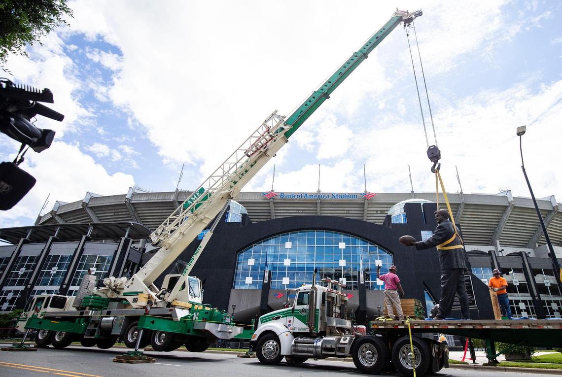 Construction workers use a crane to remove the statue of Jerry Richardson in front of the Bank of America Stadium in Charlotte, NC on Wednesday, June 10, 2020. Richardson was the founder and majority owner of the Carolina Panthers team and sold his stake after an NFL investigation substantiated allegations of both sexual and racial misconduct.