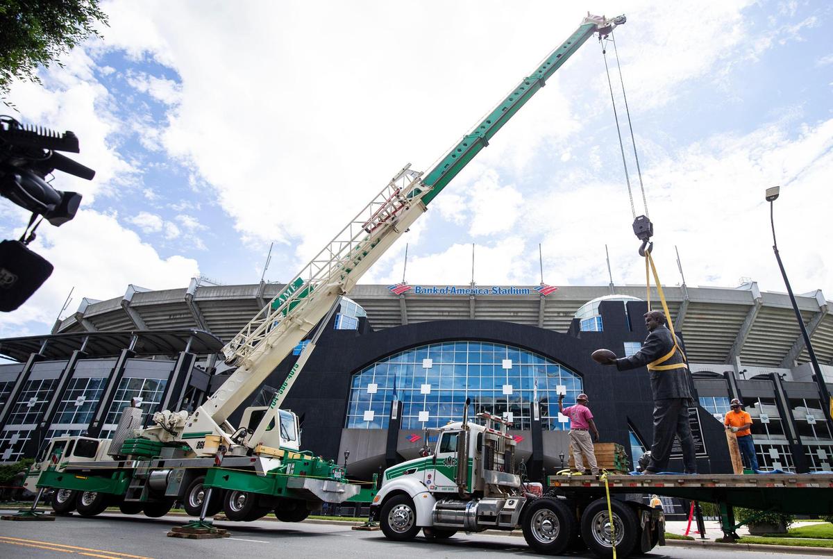 Construction workers use a crane to remove the statue of Jerry Richardson in front of the Bank of America Stadium in Charlotte, NC on Wednesday, June 10, 2020. Richardson was the founder and majority owner of the Carolina Panthers team and sold his stake after an NFL investigation substantiated allegations of both sexual and racial misconduct.