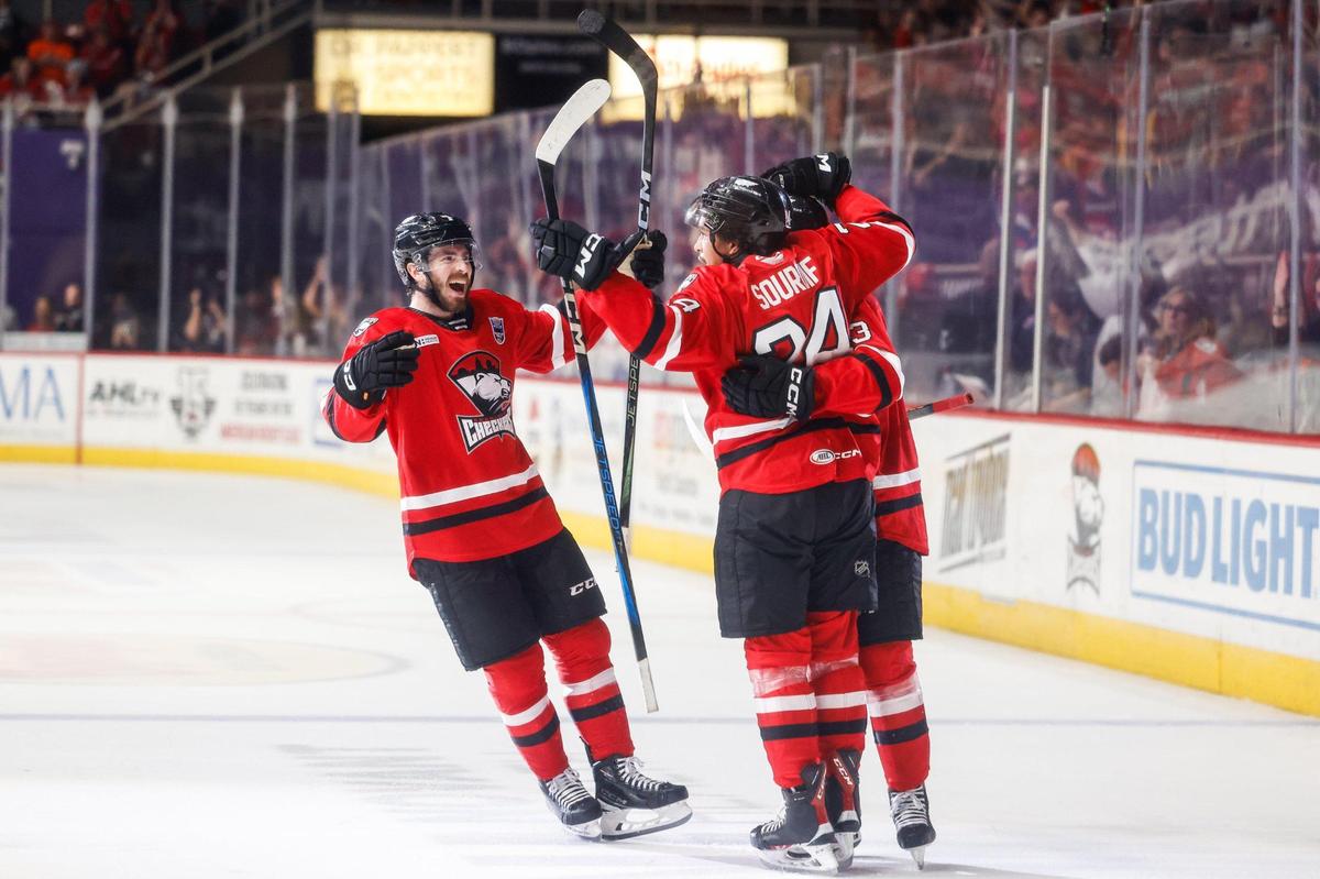 Checkers forward Justin Sourdif, center, celebrates scoring a goal with teammates during the Calder Cup opener against the Canucks at Bojangles Coliseum in Charlotte, NC on Friday, June 13, 2025.