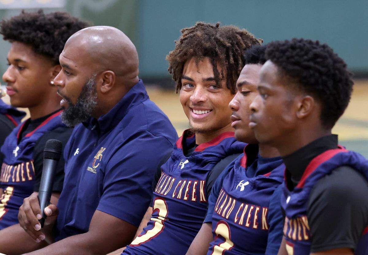 Mallard Creek Mavericks quarterback Perry Justice, center, glances over at linebacker Deuce Midgett during the Mecklenburg County Power 6 media day on Tuesday, Aug. 5, 2025 at Independence High School.