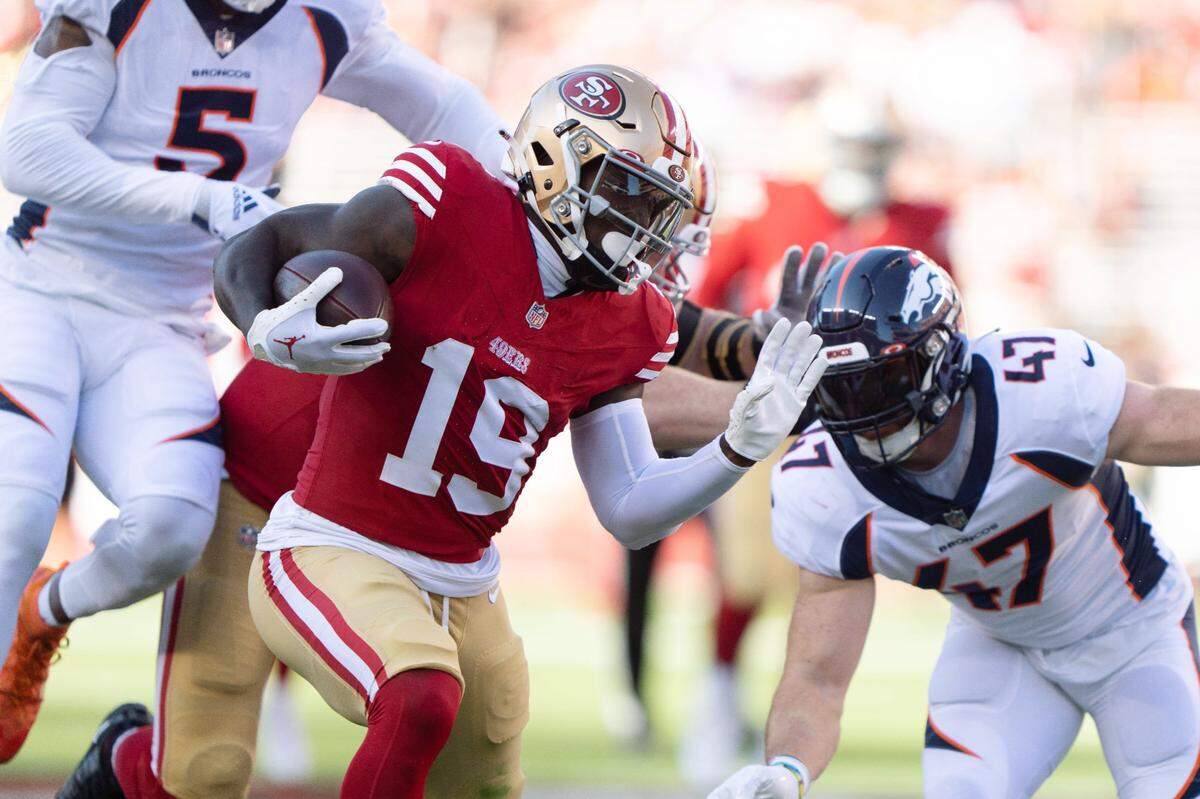 San Francisco 49ers wide receiver Deebo Samuel (19) runs during the first quarter against Denver Broncos linebacker Josey Jewell (47) and linebacker Randy Gregory (5) in a preseason game Aug. 19, 2023, at Levi’s Stadium.