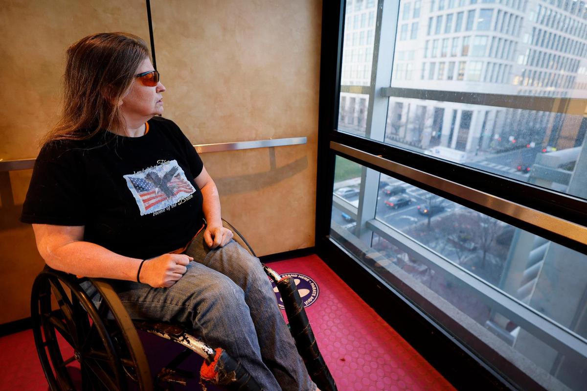 Barbara Ryan looks out of an elevator car in a parking garage in uptown where she slept while temporarily homeless on Tuesday, March 1, 2022.