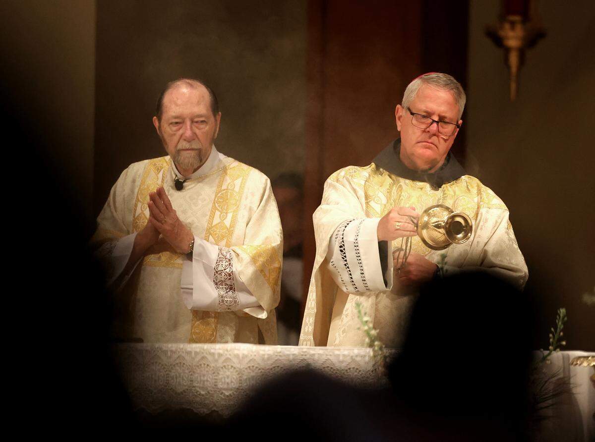 Fifth Bishop of Charlotte Michael T. Martin, right, uses a thurible to distribute incense on the altar during a Mass for Deceased Pope Francis on Wednesday at Saint Mark Catholic Church in Huntersville.