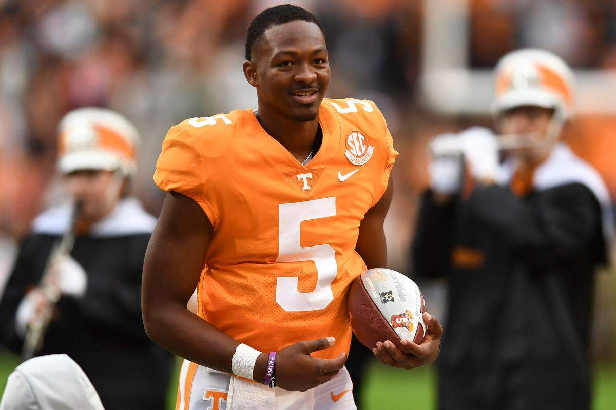 Then-Tennessee quarterback Hendon Hooker carries the ball he was presented during a pregame ceremony recognizing the team's seniors on Nov. 12, 2022 in Knoxville, Tenn. 