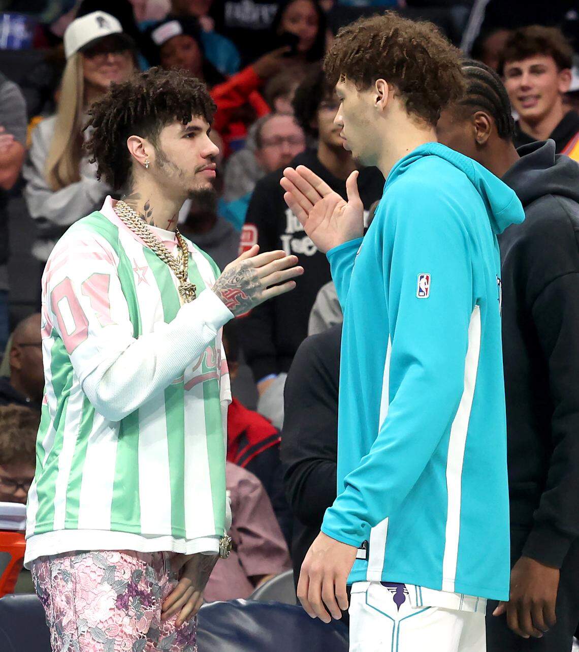 Charlotte Hornets injured guard LaMelo Ball, left, shakes hands with teammate and forward Tidjane Salaun, right, prior to the team’s game against the Denver Nuggets at Spectrum Center in Charlotte, NC on Sunday, December 7, 2025.