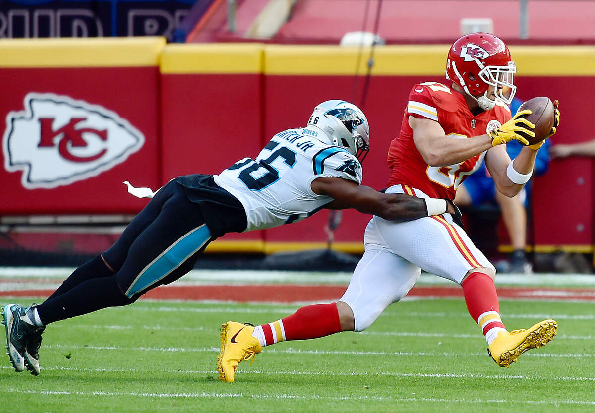 Kansas City Chiefs tight end Travis Kelce pulls in a second quarter reception while in the grasp of Carolina Panthers linebacker Jermaine Carter Sunday, November 8, 2020, at Arrowhead Stadium in Kansas City, Missouri.