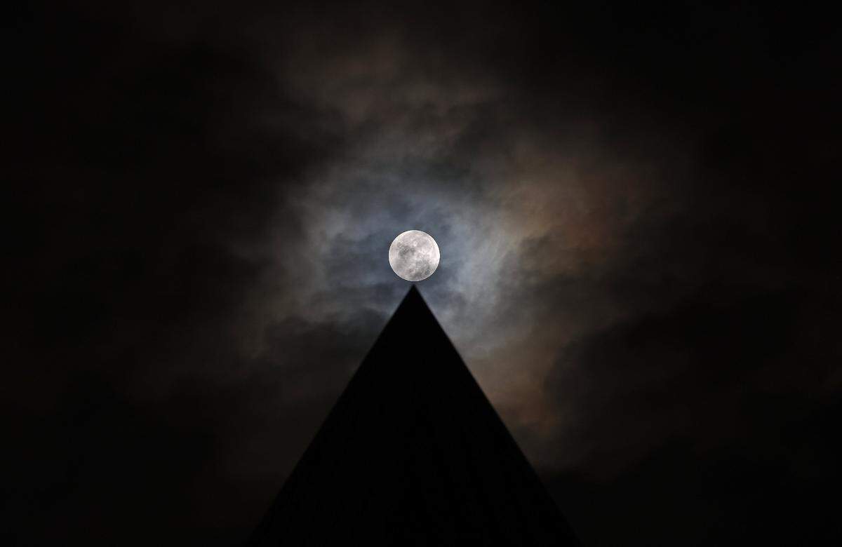 The Harvest Moon appears to sit atop the Clock Tower of Lake Park Village in Union County on Friday, September 29, 2023. The Harvest Moon signals that fall has arrived and is the last super moon of the year.