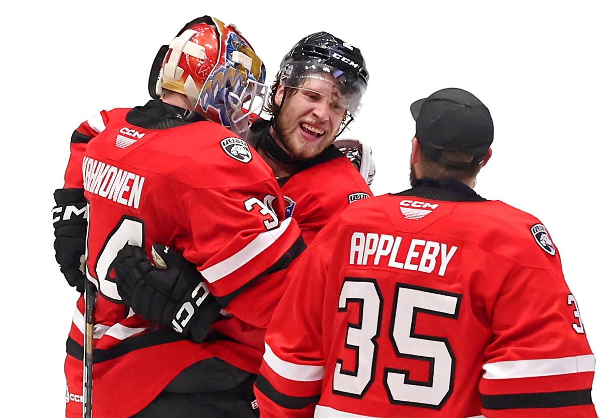 Charlotte Checkers Mike Benning, center, is congratulated by goalies Kaapo Kahkonen, left and Ken Appleby, right, following his game-winning goal against the Canucks during overtime in the Calder Cup on Sunday, June 15, 2025 at Bojangles Coliseum in Charlotte, NC. The series is tied at 1-1.
